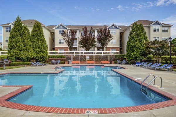 Resort-style swimming pool with sun loungers at Avant at Steele Creek luxury apartments
