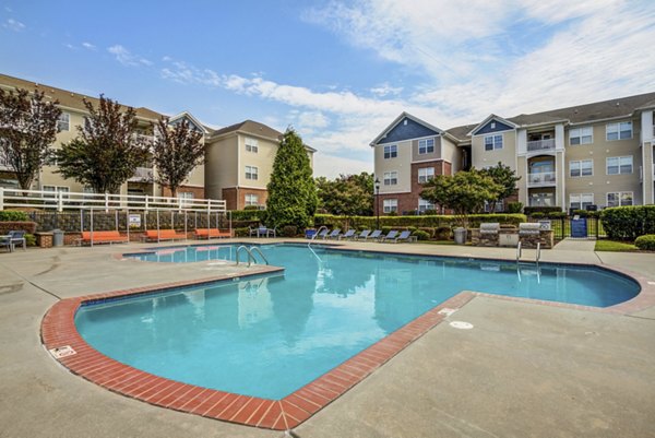 Inviting pool with sun loungers at Avant at Steele Creek luxury apartments, perfect for relaxation and social gatherings