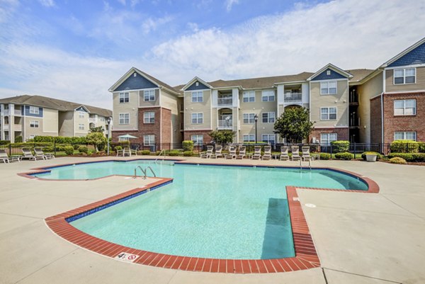 Luxurious pool with lounge chairs at Avant at Steele Creek, ideal for relaxation and social gatherings