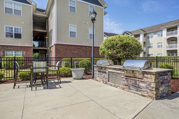 Outdoor recreation area with picnic tables and playground at Avant at Steele Creek apartments