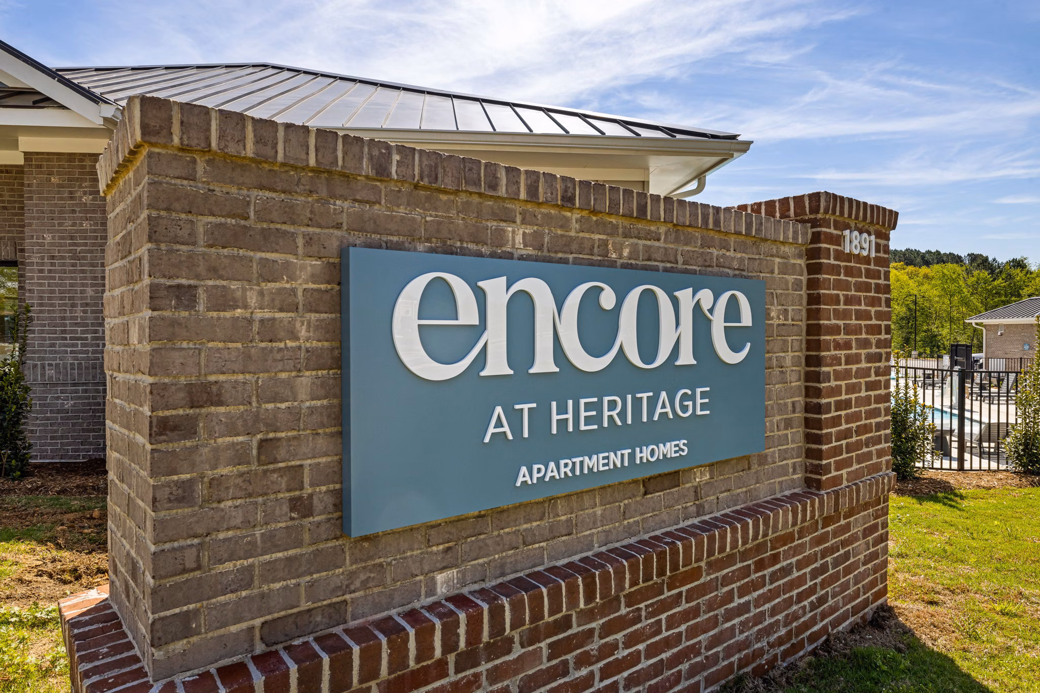 Encore at Heritage Apartments: Elegant signage display at luxury apartments in serene setting