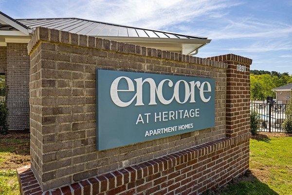 Encore at Heritage Apartments: Elegant signage display at luxury apartments in serene setting