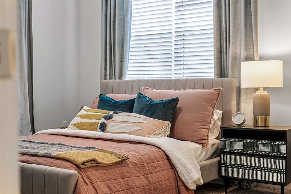 Spacious bedroom with modern furnishings in Encore at Heritage Apartments, a luxury Greystar community