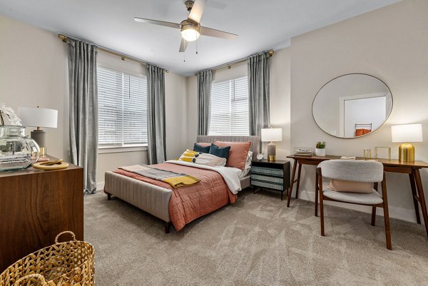 Contemporary bedroom with stylish decor at Encore at Heritage Apartments, offering luxury living and comfort