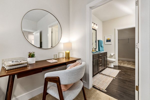 Bedroom with modern decor and large windows at Encore at Heritage Apartments