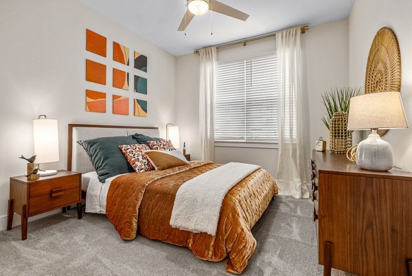 Cozy bedroom with plush bedding and modern decor in Encore at Heritage Apartments