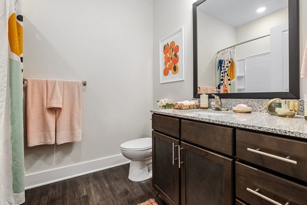 Modern bathroom with sleek fixtures at Encore at Heritage Apartments, showcasing luxury living spaces near top amenities