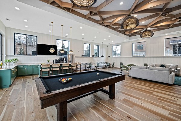 Clubhouse featuring modern design and plush seating at Encore at Heritage Luxury Apartments