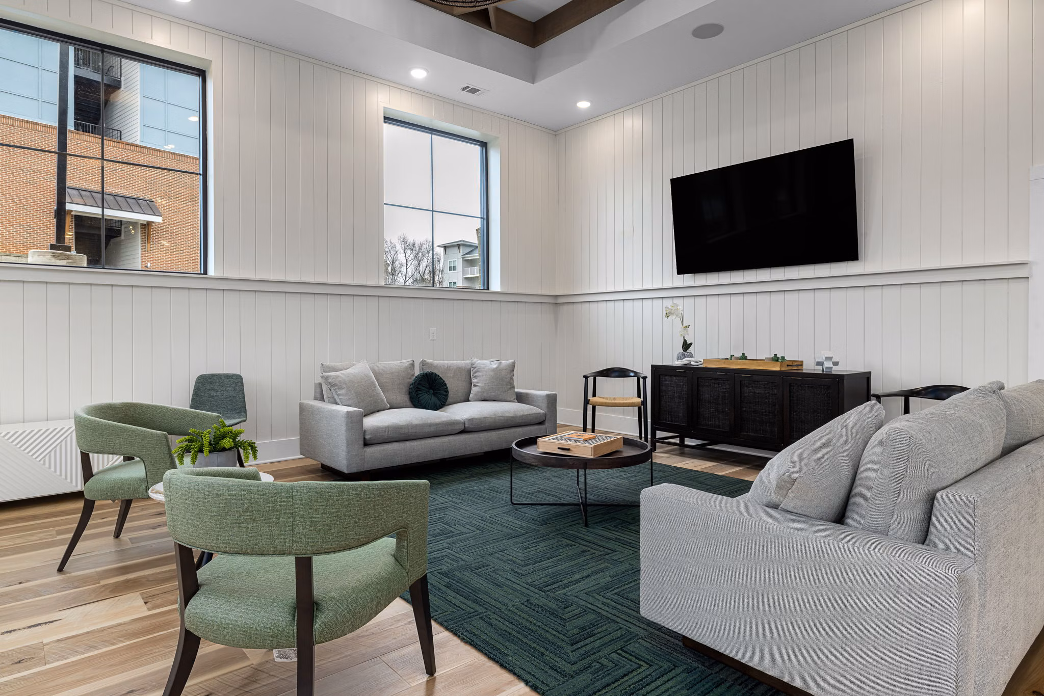 Clubhouse featuring modern design and cozy seating areas at Encore at Heritage Apartments