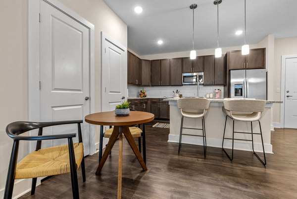 Dining area with elegant furnishings at Encore at Heritage Apartments, featuring modern lighting and open space for gatherings