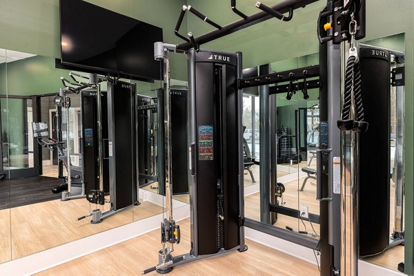 Modern fitness center with state-of-the-art equipment at Encore at Heritage Apartments, offering comprehensive workout options