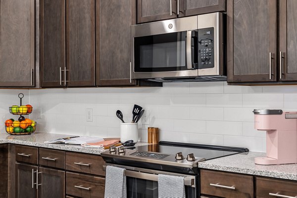 Modern kitchen with stainless steel appliances and quartz countertops at Encore at Heritage Apartments in Charlotte
