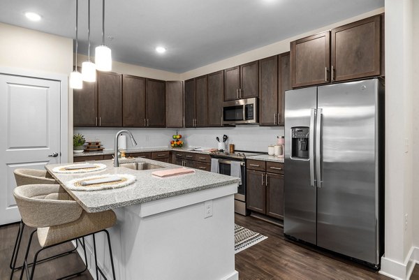 Modern kitchen with stainless steel appliances at Encore at Heritage Apartments