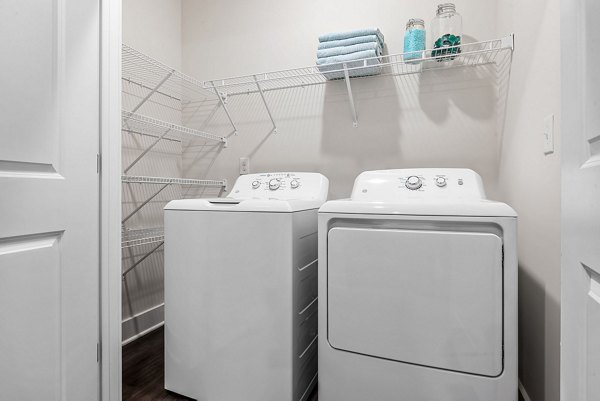 Modern laundry room with high-efficiency machines at Encore at Heritage Apartments