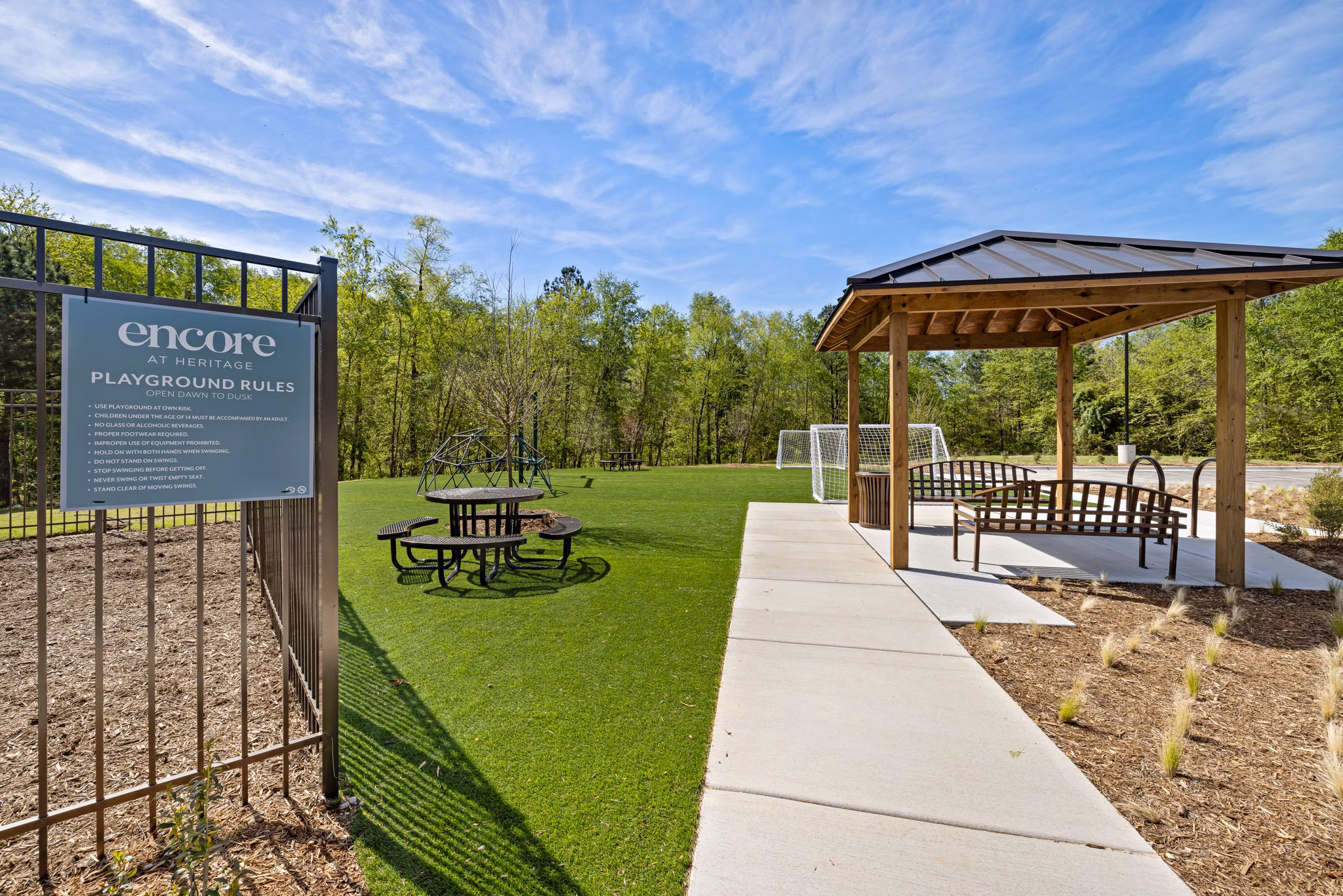 Modern playground with safe equipment at Encore at Heritage Apartments for family-friendly living