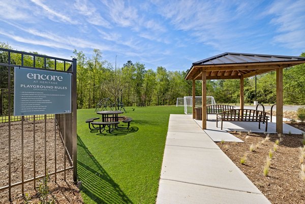 Modern playground with safe equipment at Encore at Heritage Apartments for family-friendly living
