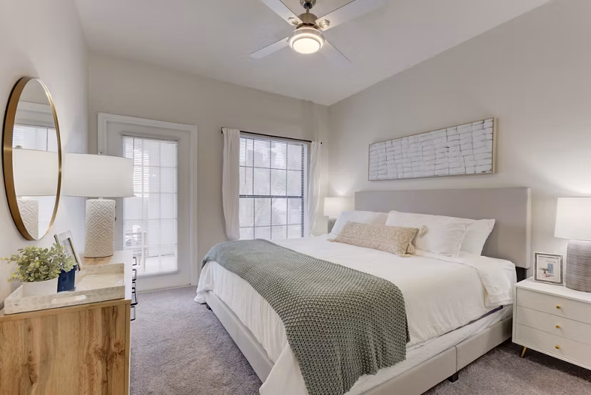 Cozy bedroom with modern furnishings at Sendero Ridge Apartments in a luxurious Greystar community setting