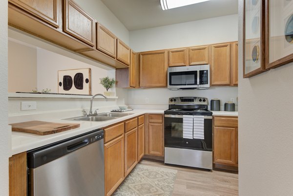Modern kitchen with stainless steel appliances at Sendero Ridge Apartments