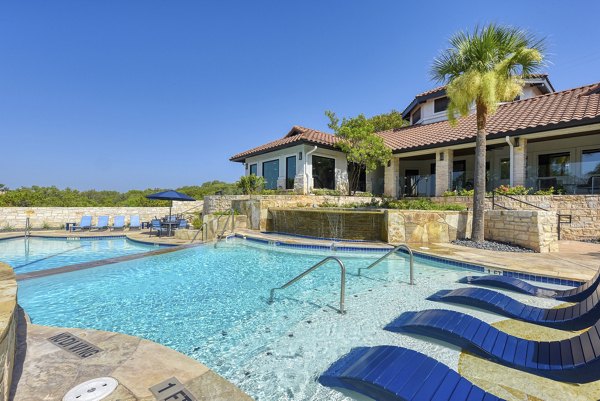 Resort-style pool with lounge seating at Sendero Ridge Apartments for luxury living