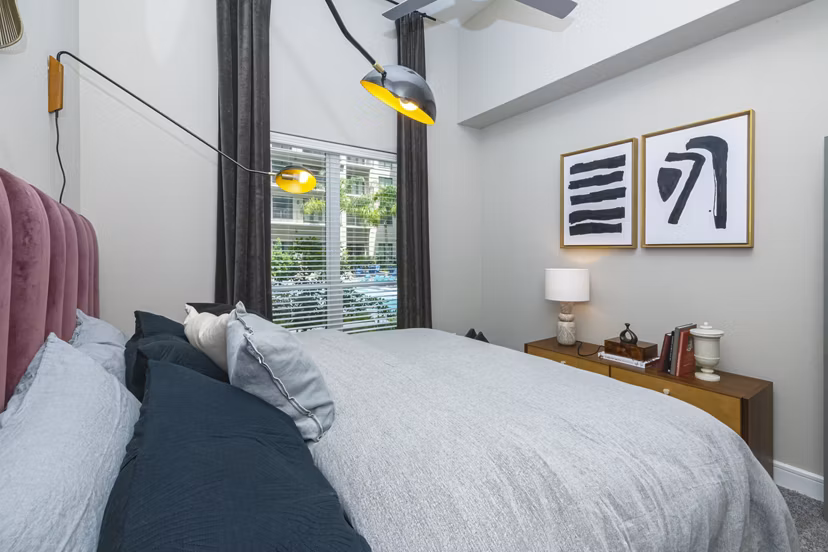 Cozy bedroom with modern furnishings at Canal 1535 Apartments, offering luxury living in a prime location