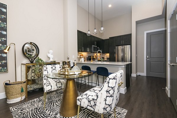 Dining area featuring sleek modern furniture and ambient lighting at Canal 1535 Apartments