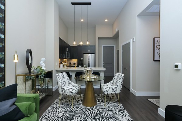 Dining area with modern furnishings and ample natural light at Canal 1535 Apartments, luxury living in New Orleans