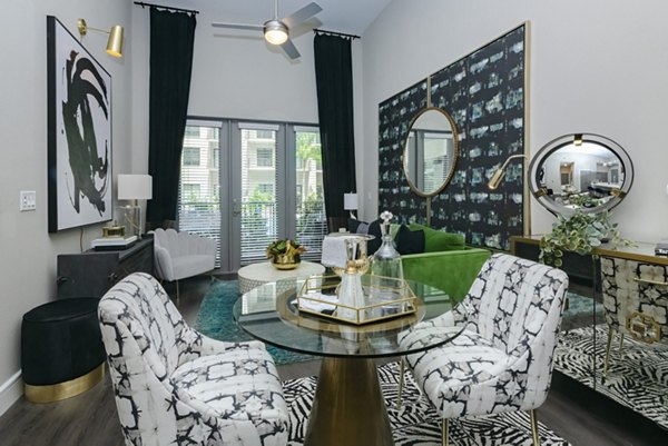 Dining area with sleek modern furnishings at Canal 1535 Apartments, showcasing luxury living in a sophisticated ambiance