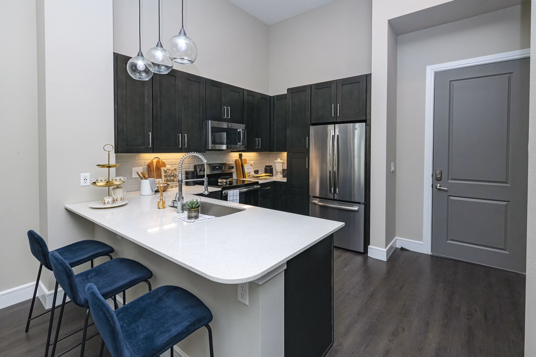 Modern kitchen with stainless steel appliances and granite countertops at Canal 1535 Apartments