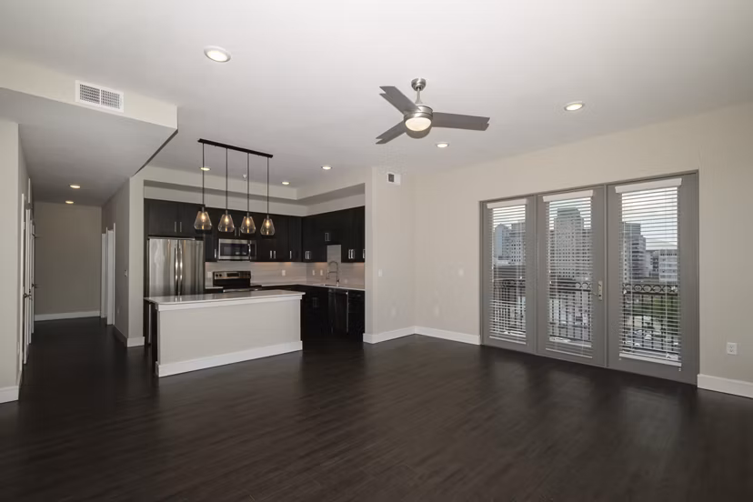 Modern living room with sleek furnishings and large windows at Canal 1535 Apartments, luxury living in a prime neighborhood