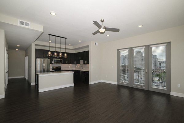Modern living room with sleek furnishings and large windows at Canal 1535 Apartments, luxury living in a prime neighborhood