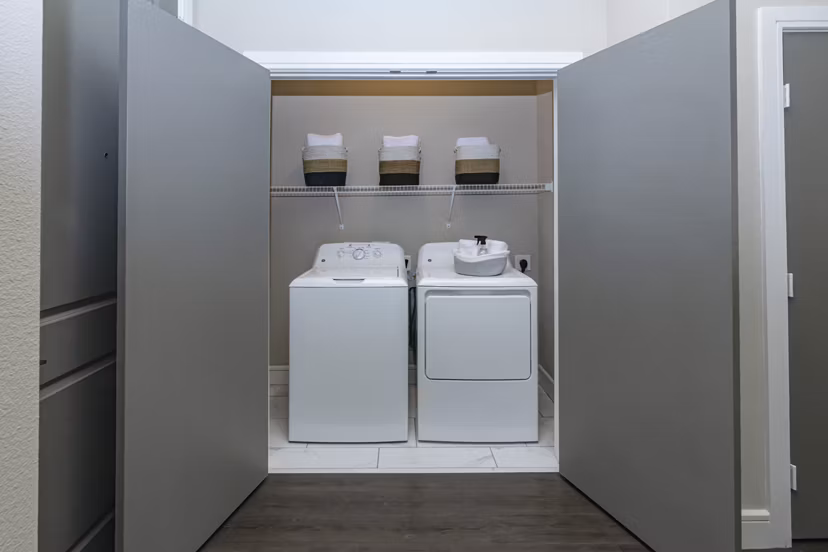Laundry room with modern appliances at Canal 1535 Apartments, a luxury property offering premium amenities and spacious living spaces