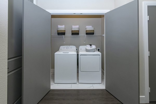 Laundry room with modern appliances at Canal 1535 Apartments, a luxury property offering premium amenities and spacious living spaces