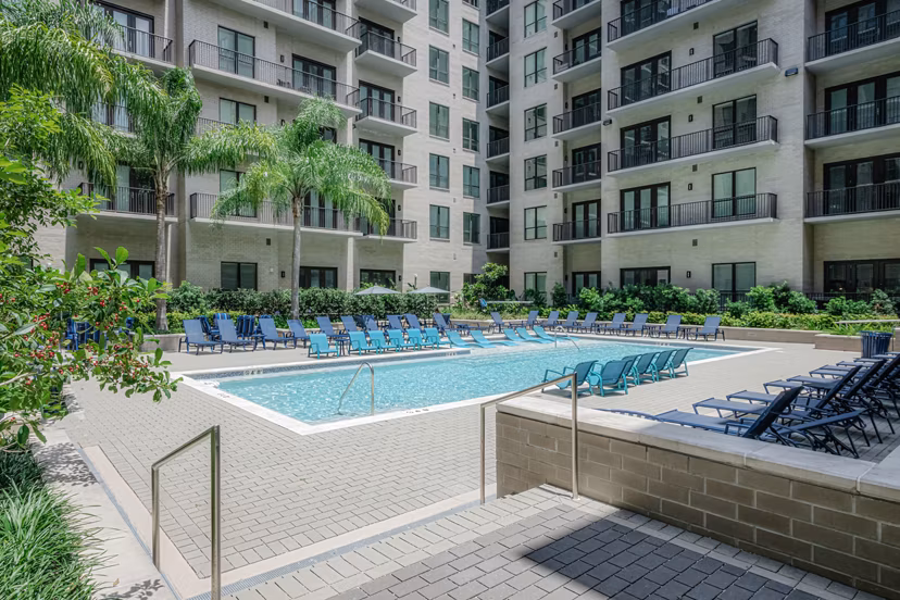 Resort-style pool at Canal 1535 Apartments with surrounding lounge chairs, perfect for relaxation and leisure in a luxury city setting