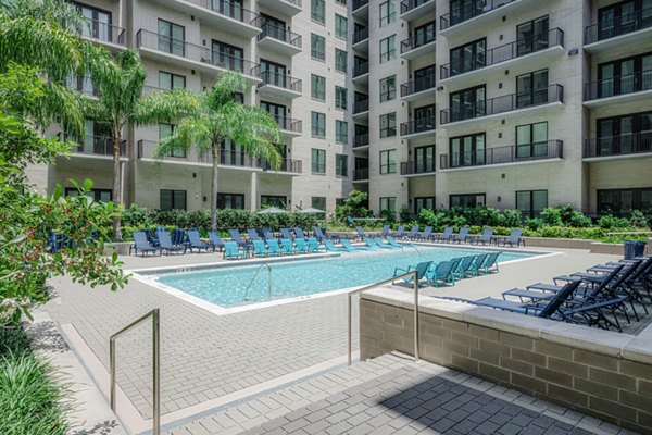 Resort-style pool at Canal 1535 Apartments with surrounding lounge chairs, perfect for relaxation and leisure in a luxury city setting