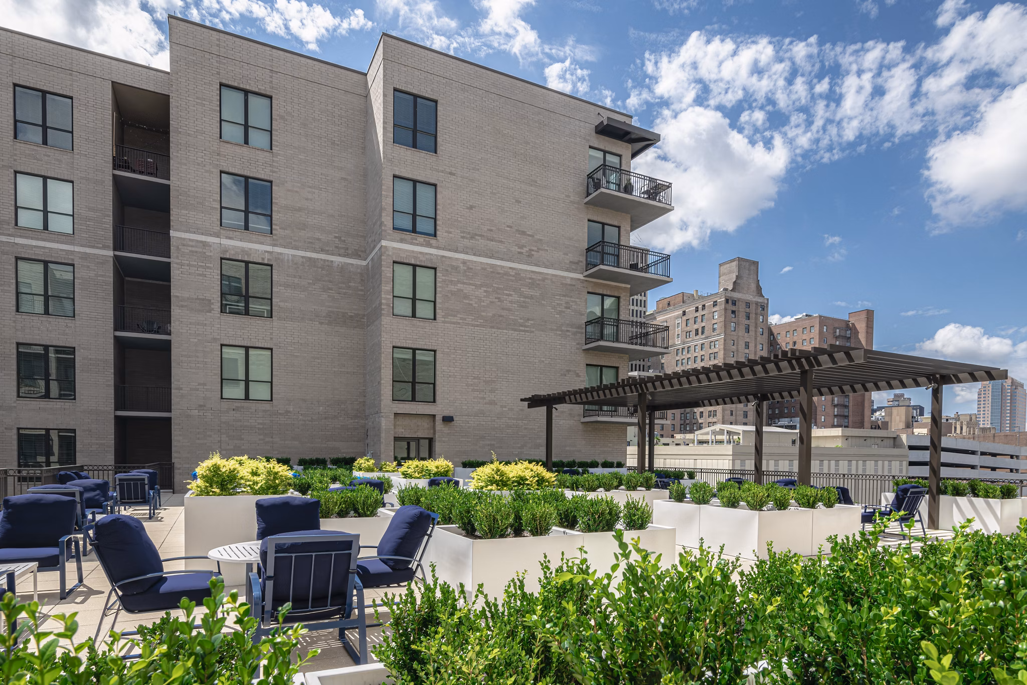 Spacious courtyard at Canal 1535 Apartments featuring lush greenery and seating areas, perfect for relaxation and outdoor gatherings