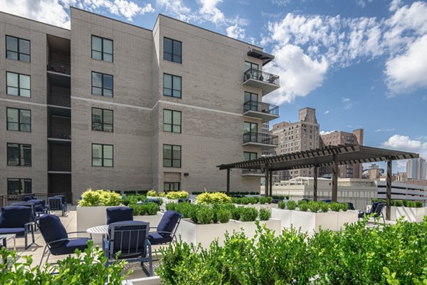 Spacious courtyard at Canal 1535 Apartments featuring lush greenery and seating areas, perfect for relaxation and outdoor gatherings