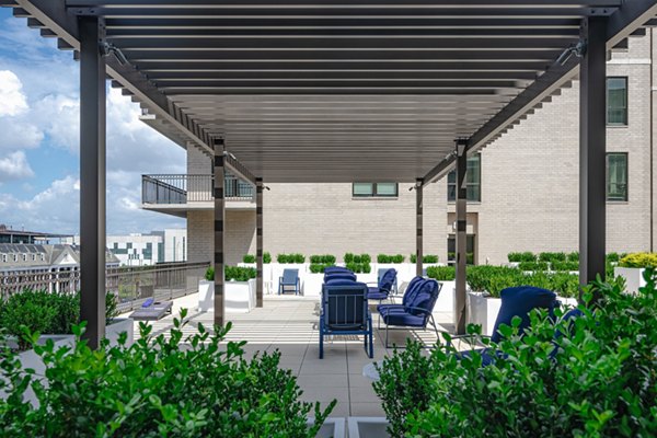 Courtyard with modern seating and lush greenery at Canal 1535 Apartments