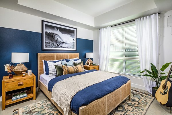 Cozy bedroom with modern furnishings at Silo Apartments, a luxury Greystar community