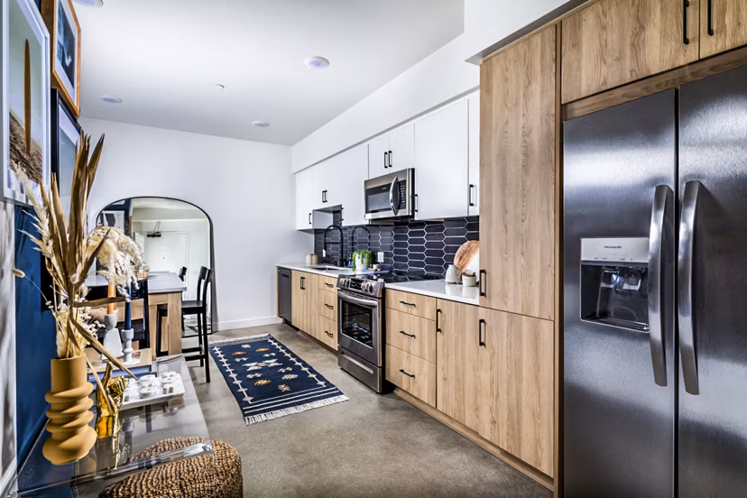 Modern kitchen with stainless steel appliances and granite countertops at Silo Apartments