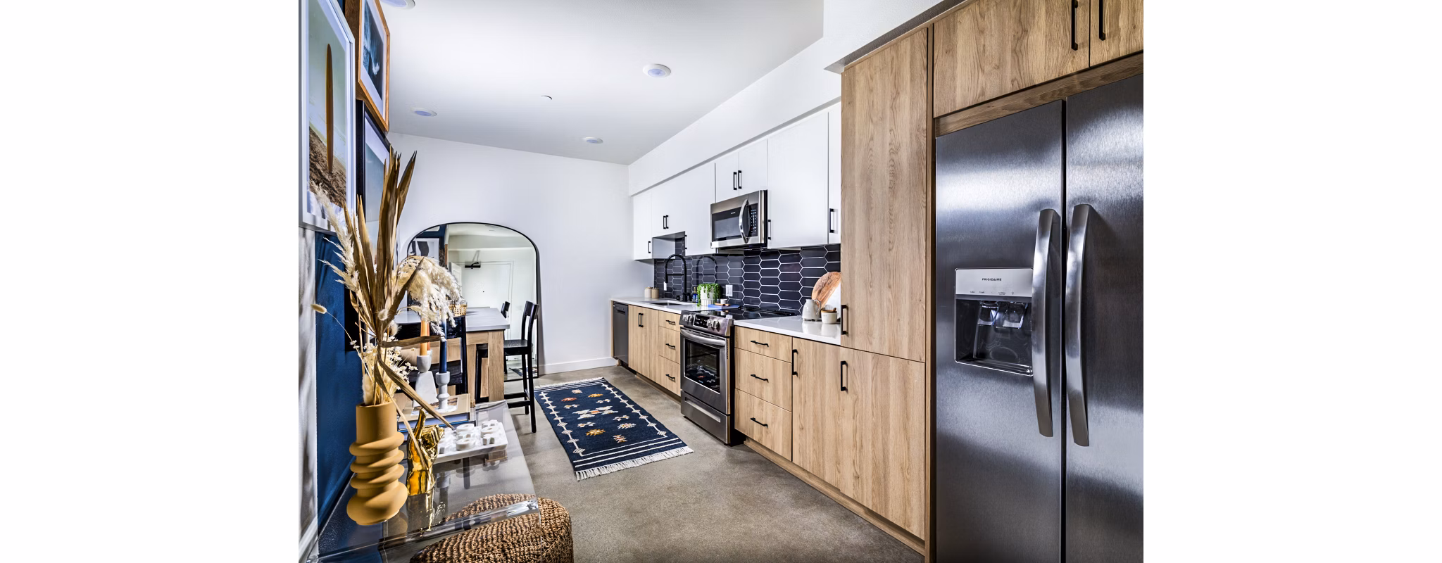 Modern kitchen with stainless steel appliances and granite countertops at Silo Apartments