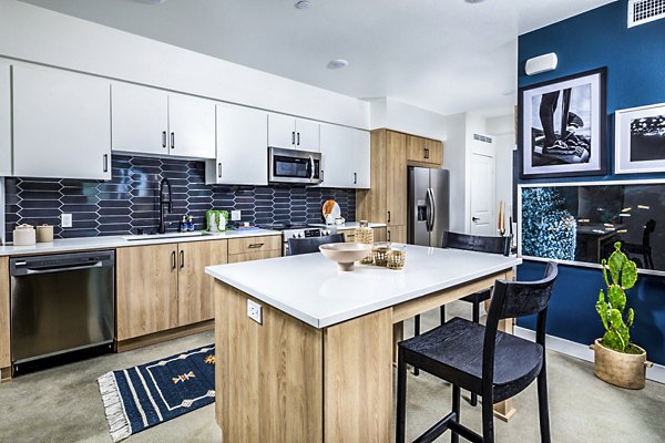 Dining area with modern kitchen fixtures at Silo Apartments, part of Greystar's luxury apartment collection