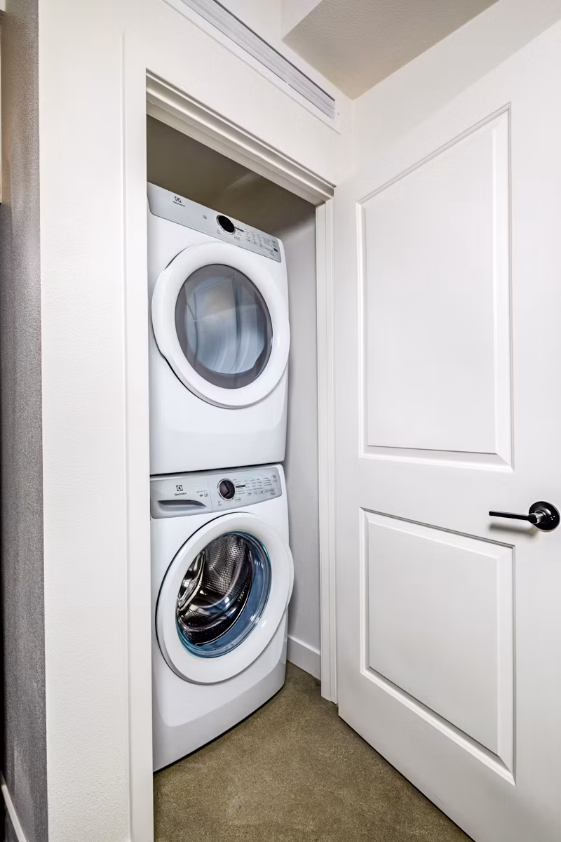 Modern laundry room with high-efficiency machines at Silo Apartments
