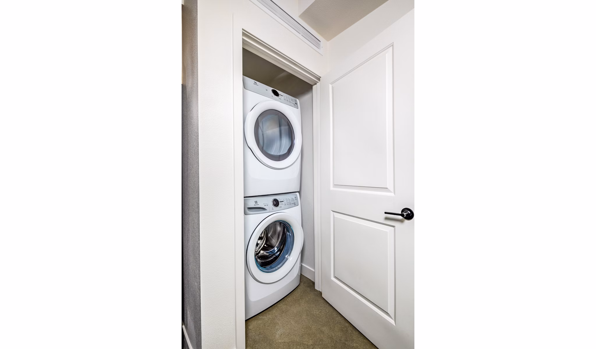 Modern laundry room with high-efficiency machines at Silo Apartments