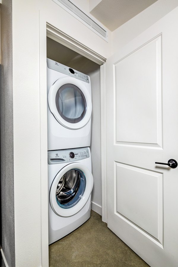 Modern laundry room with high-efficiency machines at Silo Apartments