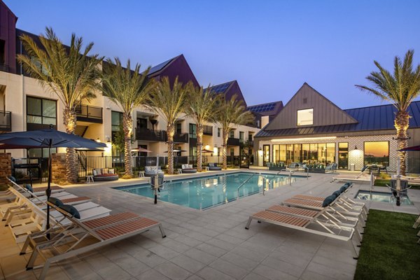 Silo Apartments: Luxurious outdoor pool with lounge chairs in a serene setting