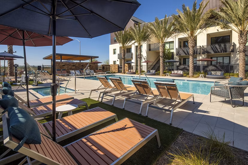 Poolside relaxation with sun loungers at Silo Apartments: Luxury living in a modern community setting