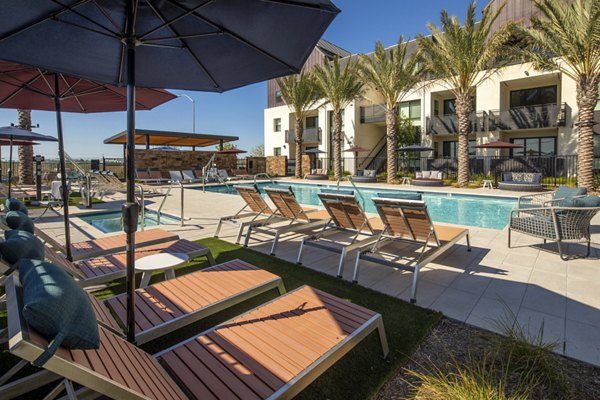 Poolside relaxation with sun loungers at Silo Apartments: Luxury living in a modern community setting