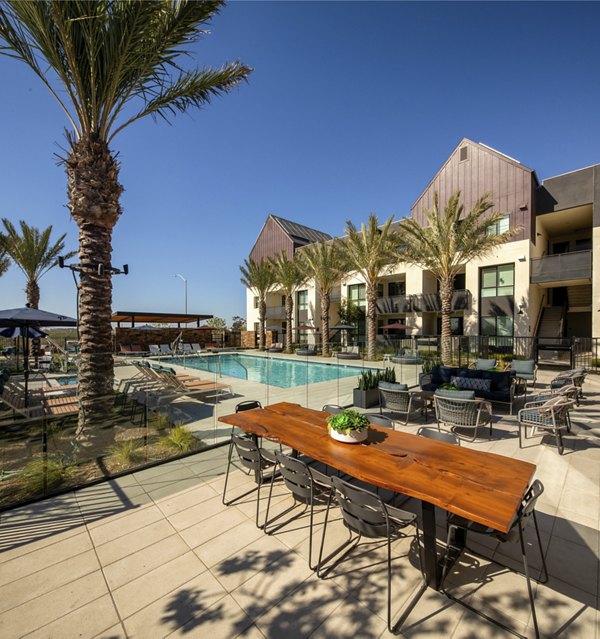 Silo Apartments: Luxurious pool with surrounding loungers and greenery, perfect for relaxation and leisure