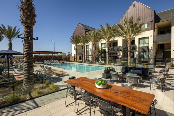 Silo Apartments: Outdoor pool with comfortable lounge chairs and modern design, offering a luxury experience in the city