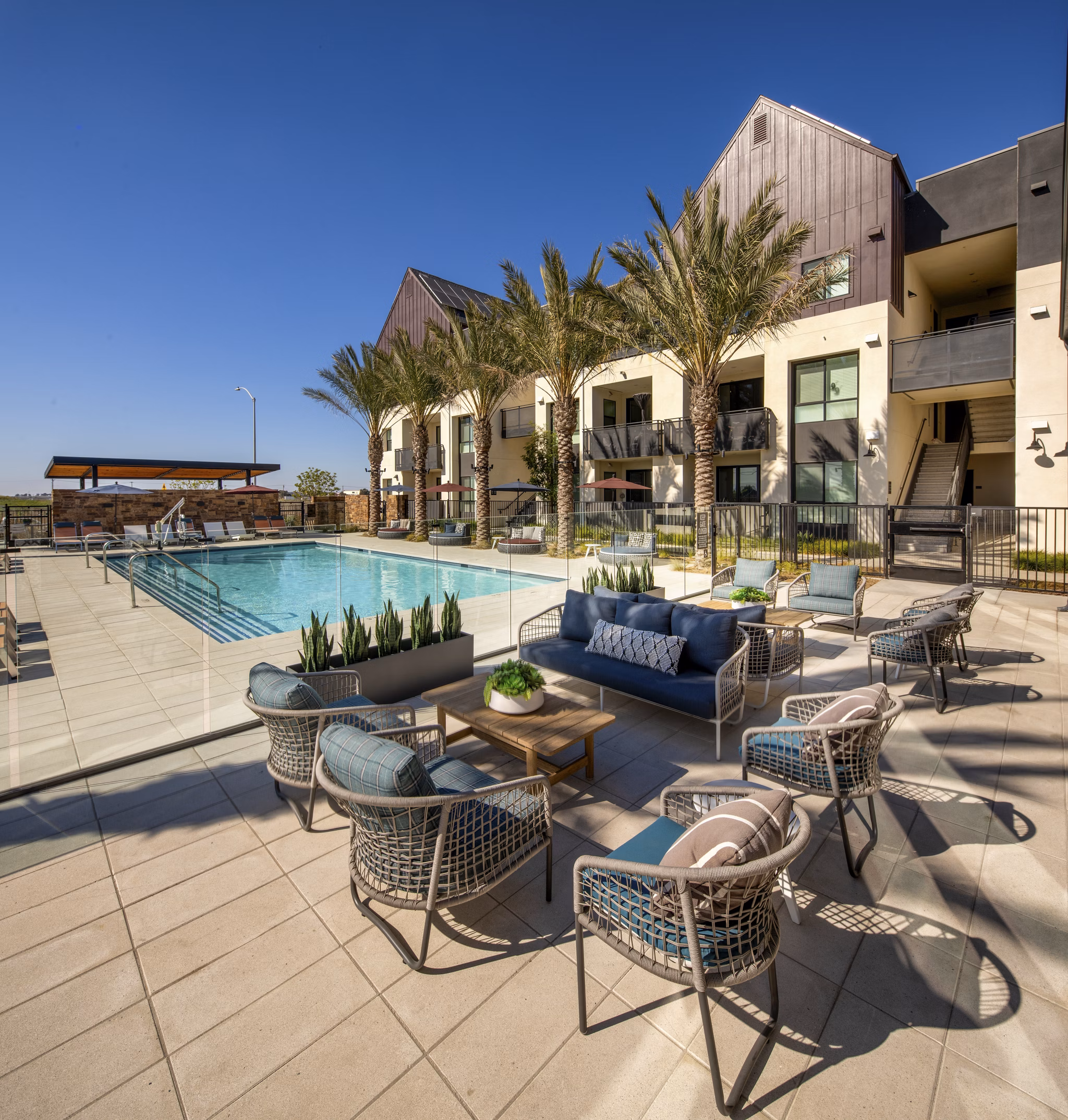 Resort-style pool at Silo Apartments, with lounge chairs and lush landscaping